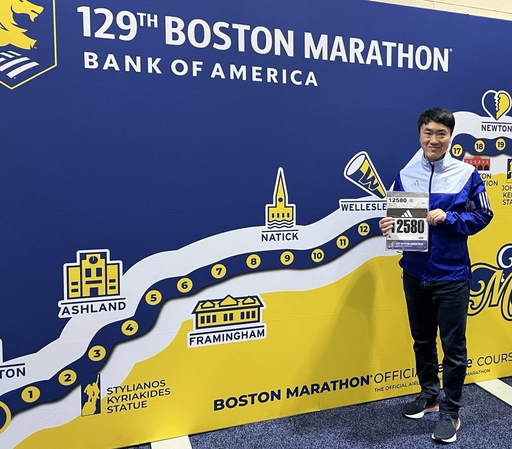 Coach Peter Nam with his race bib at the 129th Boston Marathon