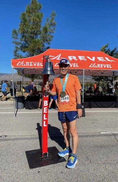 Peter ringing the finish bell after a race